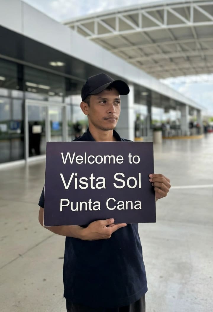 Driver at Punta Cana Airport waiting with Vista Sol Punta Cana transportation welcome sign for private transfer guests